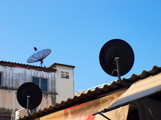 Dish television receiver on the roof Digital satellite dish or receiver antenna for space...