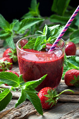 Strawberry  smoothie in glass with cocktail straw, selective focus