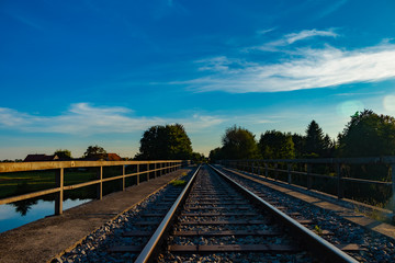 Obraz na płótnie Canvas Railway line leads through idyllic rural landscape 2