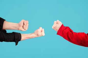 male fists are directed at each other. The symbol of the fight.