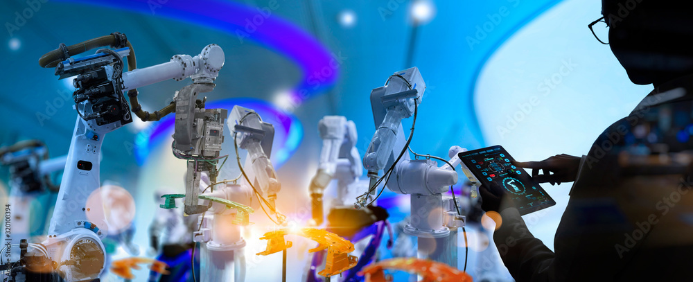 Poster Factory Female Industrial Engineer working with automation robot arms machine in intelligent factory industrial on real time monitoring system software.Digital future manufacture.