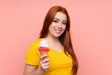 Young girl with a cornet ice cream over isolated background smiling a lot