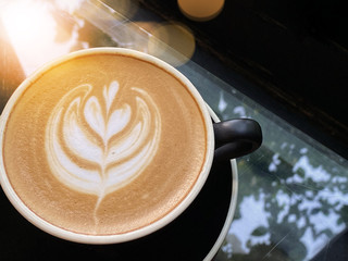 Hot art Latte Coffee in a cup on table background.