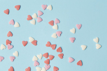 Pastel pink and white hearts on the blue background. Valentine's day, mother's day, birthday, holiday background.