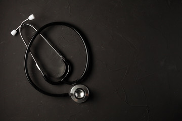 phonendoscope lies on a dark background with place for your text