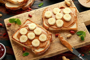 Peanut Butter and banana Sandwich on wooden board. morning breakfast