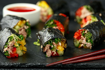 Vegetarian paleo diet nori wraps with tuna, cucumber, sweet pepper and microgreen radish sprouts