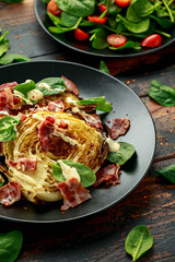 Oven roasted cabbage steaks with bacon, spinach and mayonnaise. healthy food