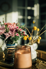 Candle and flowers in the sun 