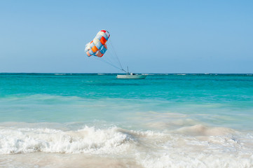 Sea foam and parasailing boat on horizon