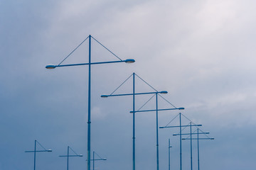 Fototapeta premium Lampposts in the port against the sky and clouds