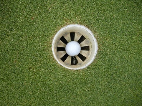 Directly Above View Of White Golf Ball In Hole On Course