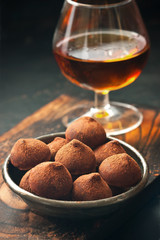 Chocolate truffles on wooden board. Atmospheric food photo