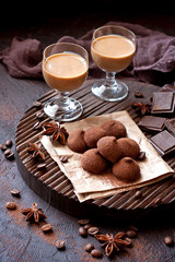  Sweet chocolate candy with liqueur in glass, dessert table