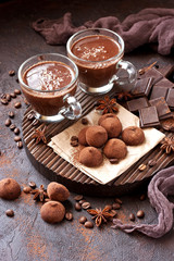 Composition with truffles candy and cocoa mug on wooden board