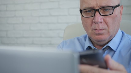 Businessman Using Laptop and Cellphone in Office Room, Businessperson Managing Company Information