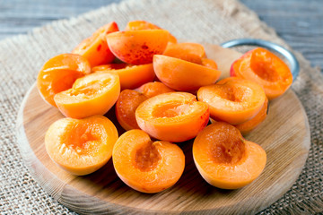 Fresh halves of apricots on a cutting board