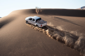 car climbing sand dune