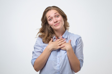 Pretty caucasian young woman is shy to hear a compliment