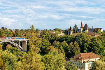 Obraz premium Panorama with Kirchenfeld bridge with running tram and Historical Museum in Bern, Switzerland. Seen from Bundesterrasse