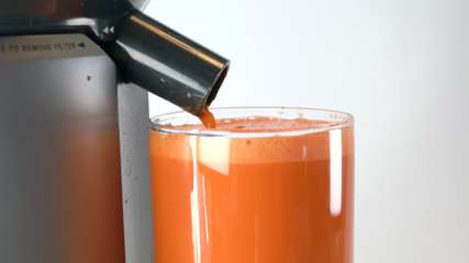 juicing carrots into glass top 