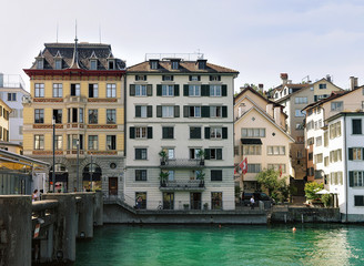 Zurich, Switzerland - September 2, 2016: Historical Buildings at Limmat River Quay of Zurich, Switzerland. People on the background