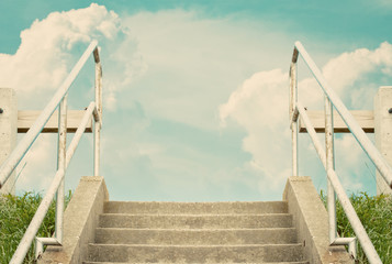 Stairs leading to cloudy sky