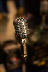 Silver vintage microphone  on blured background