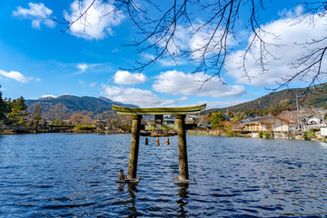 Golden Scale Lake and Yufu Mountain in winter sunny day with clear blue sky. This popular sightseeing spot commonly viewed and photographed by tourist. Yufuin, Oita Prefecture, Japan