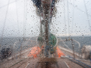 drops on the yachts window in Drake passage in close up view