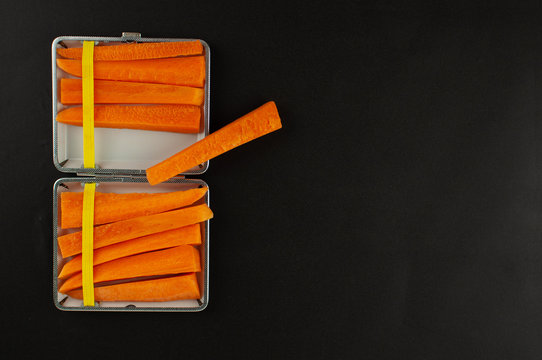 Cigarette case with carrot slices Concept of quitting smoking, healthy lifestyle