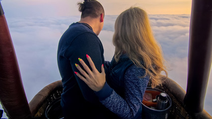 Adventure love couple on hot air balloon watermelon. Man and woman kiss hug love each other. Burner...
