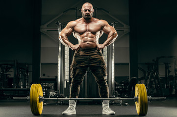 Fototapeta na wymiar Bodybuilder athletic man back muscles deadlift