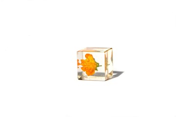 Beautiful simple yellow and white background suitable for text input. Handmade  cube with yellow flower, isolated on white background.