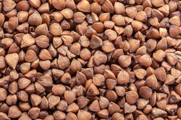 Buckwheat texture. Brown buckwheat groats. Top view, copy space
