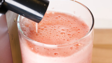 glass of strawberry juice closeup