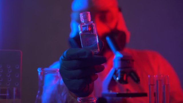 Scientist in scientific laboratory research and test medical bio material. Researcher working on developement a new drug to treat. Science and biotechnology engineering. Man doctor in a lab.