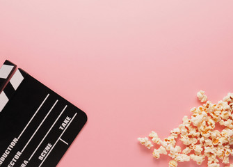 Clapboard on a pink background, movie concept