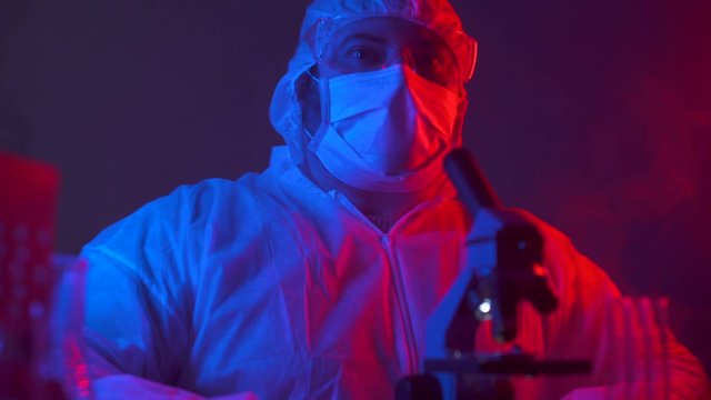 Biohazard accident in scientific laboratory researching hazardous chemicals. Scientist researcher working on a new biological weapon and a dangerous incident happens. Toxic, radioactive hazard in lab.