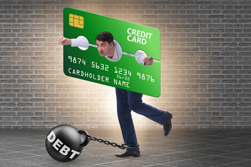 Businessman in credit card burden concept in pillory