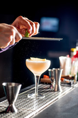 Fototapeta na wymiar bartender pours a cocktail into a glass