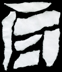 pieces of torn old paper on a black background
