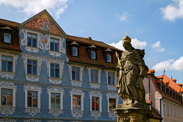 Fototapeta premium BAMBERG. GERMANY. On september 14 2019. Statue of St. Kunigunde at the bridge to the Old Townhall at the Regnitz river. built 1750 from Johann Peter Benkert. Bamberg, Germany.