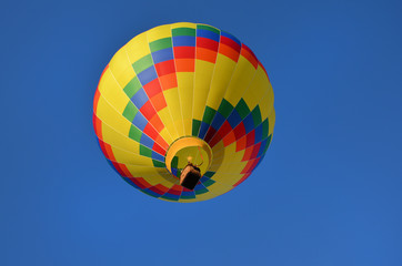 multi-colored hot air balloon against the blue sky 