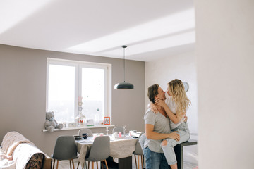 Loving couple in a bright room near the table