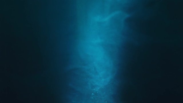 Paint fall into water which is twist. Spin acrylic ink drip into liquid. Visual effect bullet time, frozen moment, flow motion. Cloud fraction of color is spray drop. Slow motion cosmic video magic.