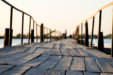 Boardwalk bridge over the lake in the morning sun