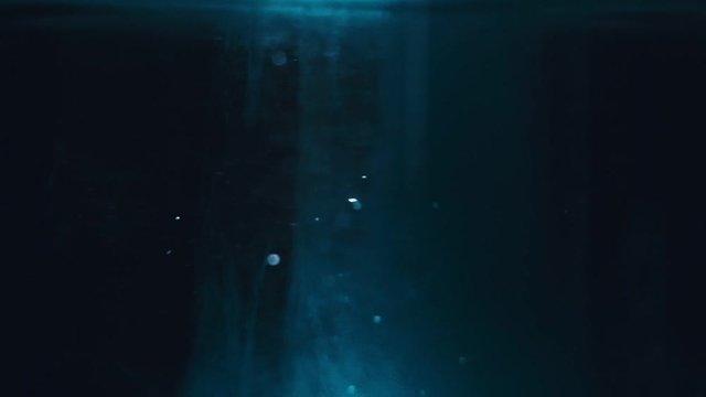 Paint fall into water which is twist. Spin acrylic ink drip into liquid. Visual effect bullet time, frozen moment, flow motion. Cloud fraction of color is spray drop. Slow motion cosmic video magic.