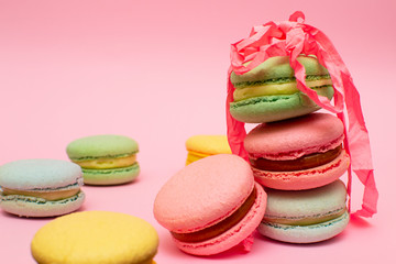 Fresh Bright Colored Macarons, or Macaroons on a Pink Background