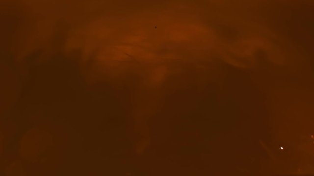 Paint fall into water which is twist. Spin acrylic ink drip into liquid. Visual effect bullet time, frozen moment, flow motion. Cloud fraction of color is spray drop. Slow motion cosmic video magic.